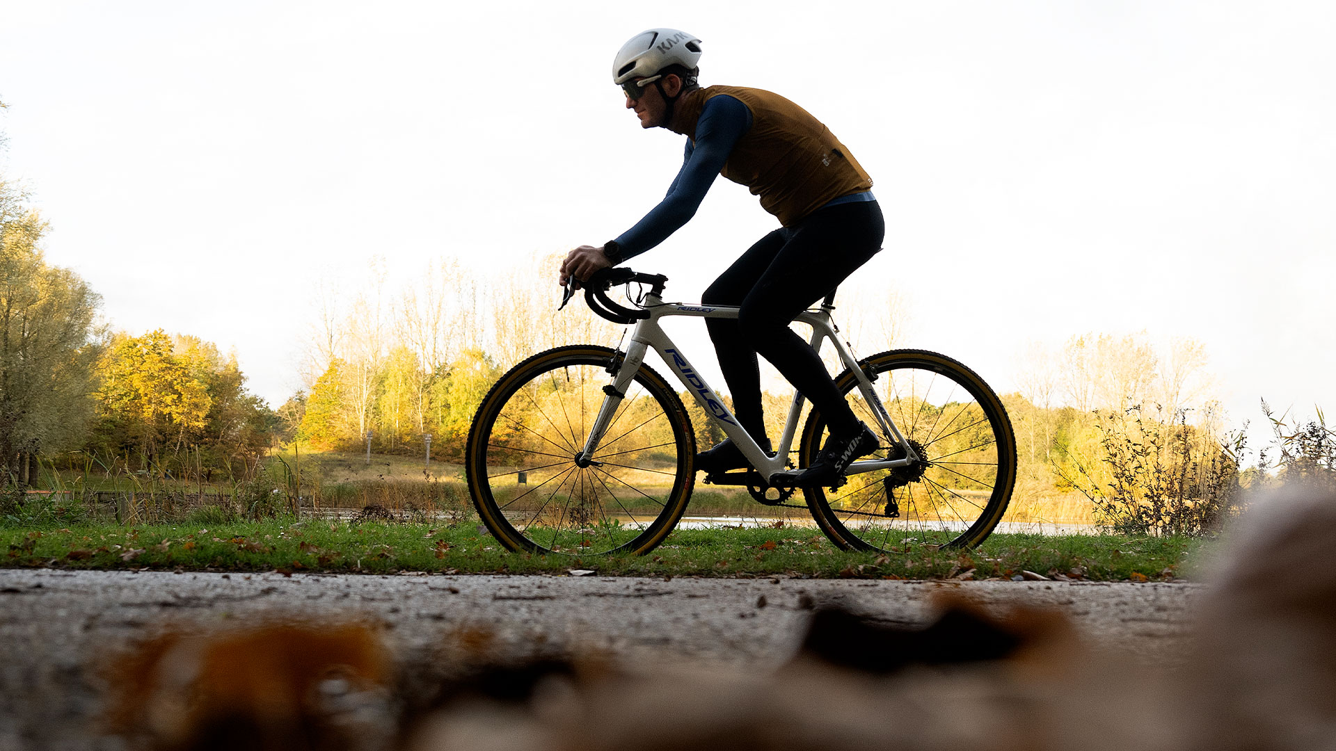 Mand cykler gennem skovområde.