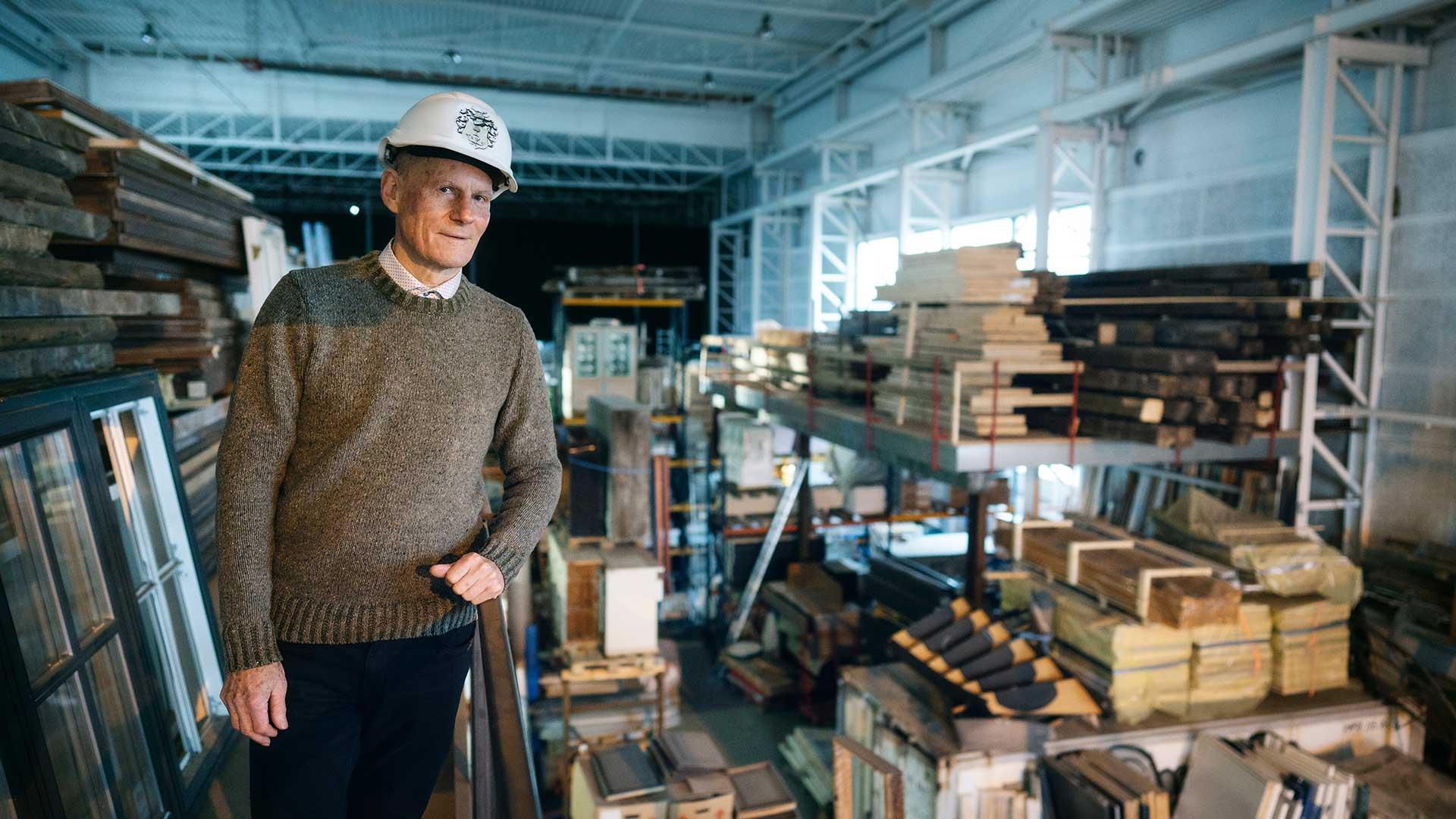 The Aarhus-based property developer Olav de Linde stands in his warehouse filled with building materials that need to be recycled.