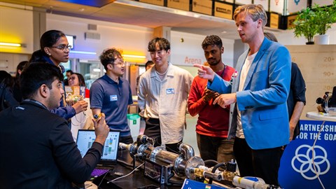 Six participants of Next Generation Water Action in talks over a prototype