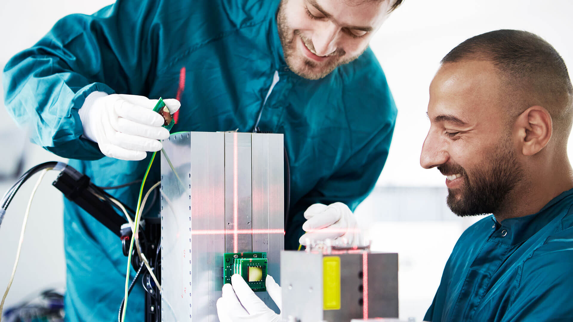 2 men holding circuit boards